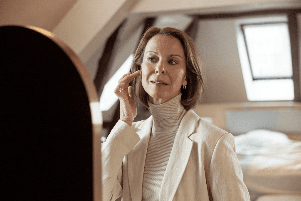 Woman smiling putting in a comfortable hearing aid